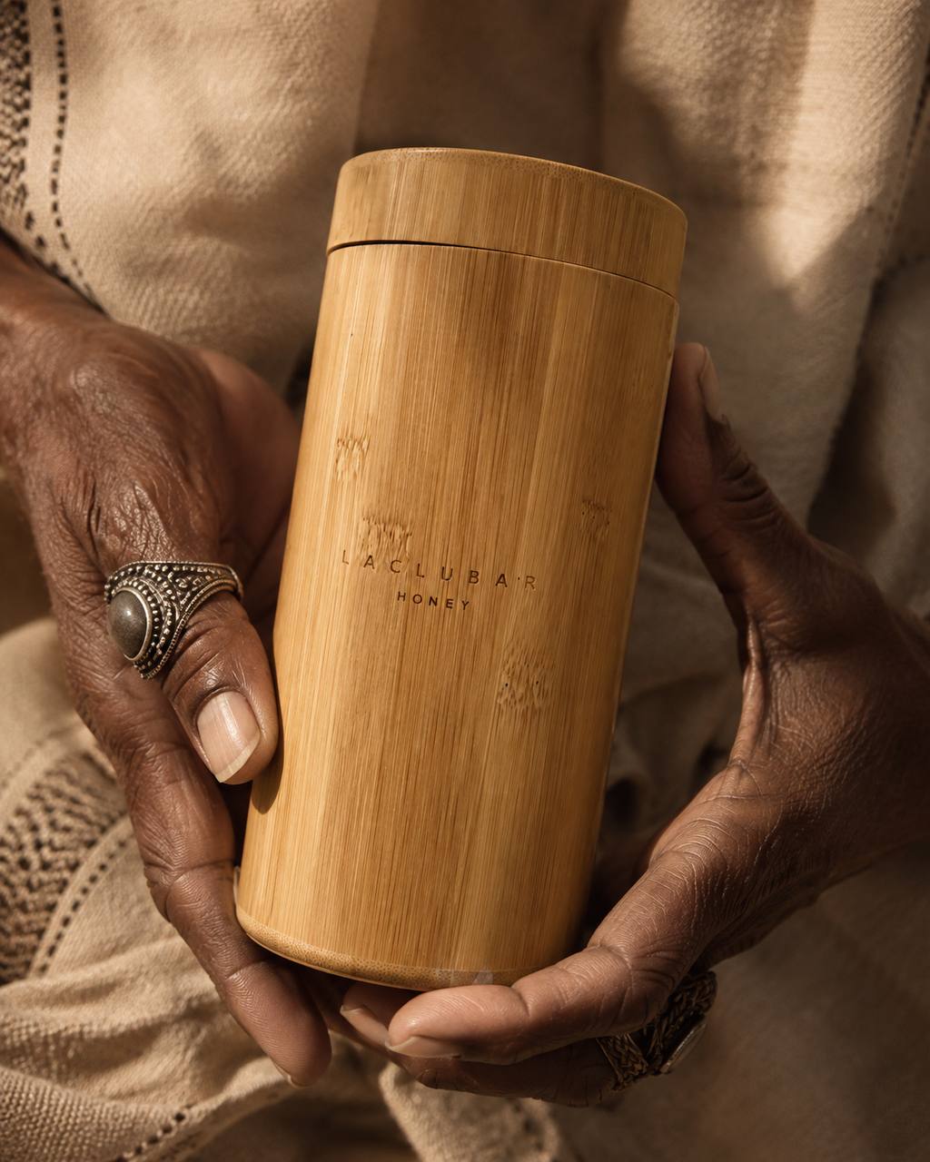 Laclubar brand image of hands holding a bamboo vessel